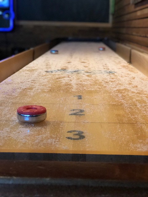 Shuffleboard table available in our pub room